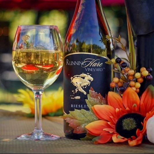 Bottle of riesling and a wine glass filled with wine.