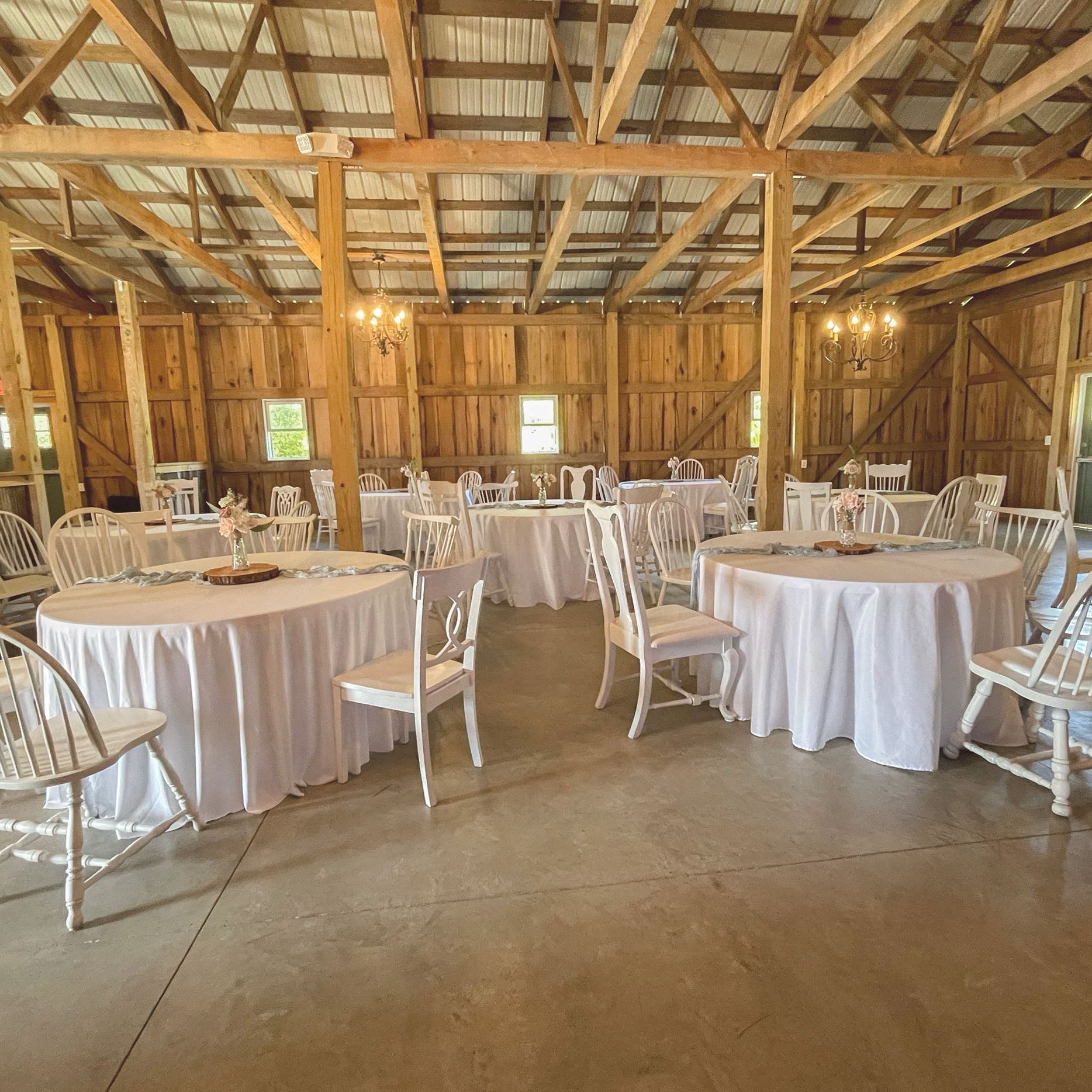 interior of barn space with white tables and chairs